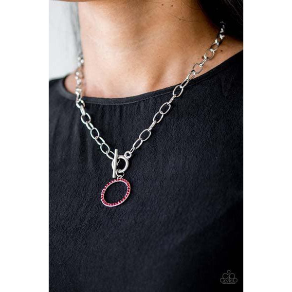 Paparazzi All In Favor - Red Necklace & Earrings Set  Encrusted in fiery red rhinestones, a bubbly silver pendant swings below the collar for a colorfully casual look. Features a toggle closure.