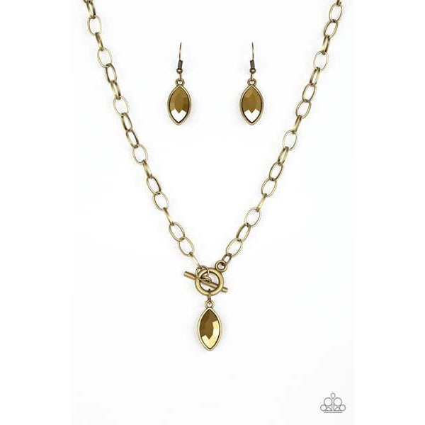 Paparazzi Club Sparkle - Brass Necklace & Earrings Set  Featuring a regal marquise style cut, a glittery aurum rhinestone swings from the bottom of a brass chain below the collar for a classic look. Features a toggle closure.