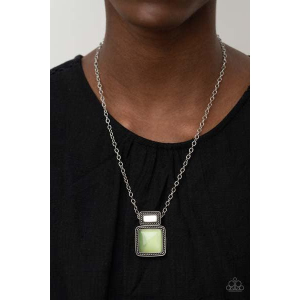 Paparazzi Ethereally Elemental - Green Necklace & Earrings Set  A shell-like accent is pressed into the center of a studded silver frame that sits atop a silver rope-like frame that is dotted with a square Green Ash cat's eye stone. The colorful pendant swings from a shiny silver chain, creating an ethereal pendant below the collar. Features an adjustable clasp closure.
