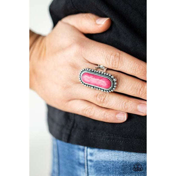 Paparazzi Sedona Scene - Pink Stretch Ring  An oblong pink stone is nestled inside an oversized studded silver frame, creating a colorfully rustic centerpiece atop the finger. Features a stretchy band for a flexible fit.