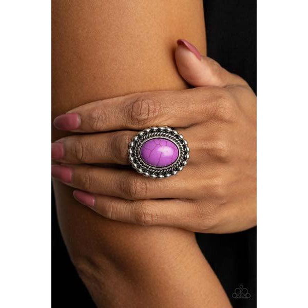 Paparazzi Sedona Soul - Purple Stretch Ring  An oversized oval purple stone is pressed into a textured silver frame bordered in shiny silver studs, creating a dramatic stone centerpiece atop the finger. Features a stretchy band for a flexible fit.
