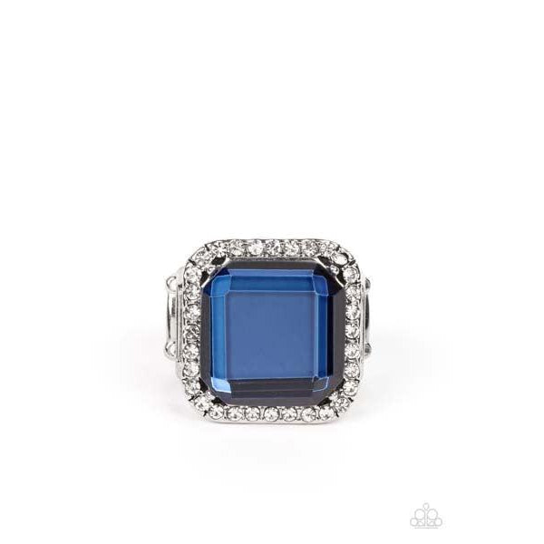 Paparazzi Slow Burn - Blue Stretch Ring  A lavish square Skydiver gem, encased in a border of dainty white rhinestones, makes a head-turning centerpiece as it gleams with an industrial edge atop the finger. Features a stretchy band for a flexible fit.