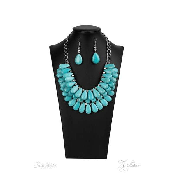 Zi Collection "The Amy" Turquoise (faux) Necklace & Earrings Set   Three trailblazing tiers of shiny silver beads and simulated turquoise teardrops fearlessly cascade into a bold tribal inspired fringe below the collar. Attached to a chunky silver chain, the groundbreaking stone compilation delicately layers into an earth-rattling statement-maker. Features an adjustable clasp closure.