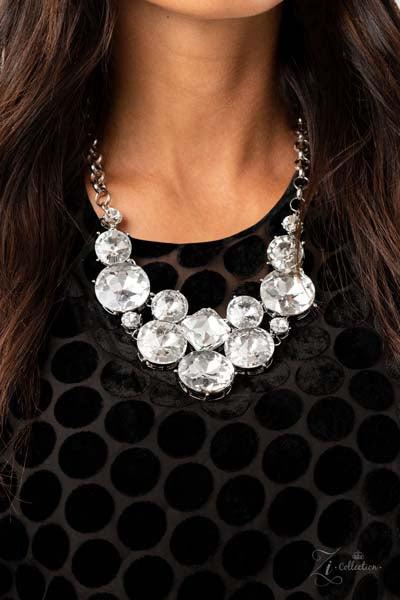 Zi Collection "Unpredictable" Necklace & Earrings Set  Varying in size and shape, a dramatic collision of oversized white rhinestones connect into an unapologetically glamorous statement piece below the collar. Attached to chunky silver links, the breathtaking display of clustered gems radiates confidence. Features an adjustable clasp closure.