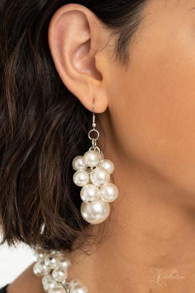 Zi Regal Pearl Statement Necklace & Earrings Set  An exaggerated display of clustered pearls elegantly sweeps below the collar. The classic white pearls gradually increase in bubbly intensity as they reach the center of the regal piece, adding over-the-top timelessness to the unapologetic pearl palette. Features an adjustable clasp closure.