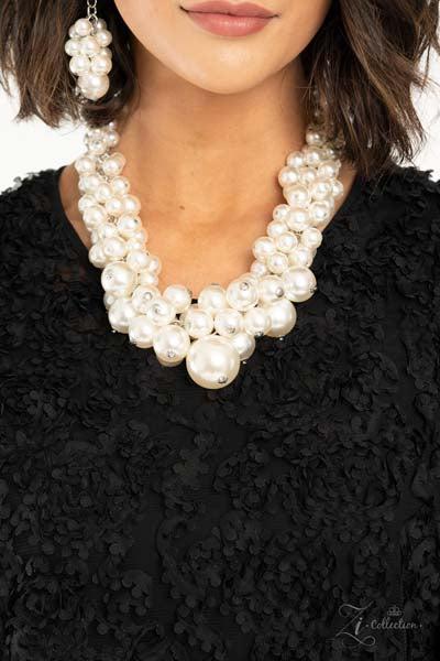 Zi Regal Pearl Statement Necklace & Earrings Set  An exaggerated display of clustered pearls elegantly sweeps below the collar. The classic white pearls gradually increase in bubbly intensity as they reach the center of the regal piece, adding over-the-top timelessness to the unapologetic pearl palette. Features an adjustable clasp closure.
