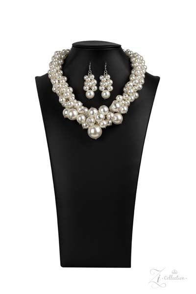 Zi Regal Pearl Statement Necklace & Earrings Set  An exaggerated display of clustered pearls elegantly sweeps below the collar. The classic white pearls gradually increase in bubbly intensity as they reach the center of the regal piece, adding over-the-top timelessness to the unapologetic pearl palette. Features an adjustable clasp closure.